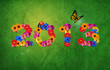 На газоне, цветочная надпись 2013 из ярких цветов, над цифрой 1 порхает бабочка.