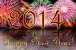 Яркие отблески новогоднего салюта и надпись с Новым 2014 годом