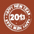 На коричневом фоне белый штамп Happy New Year 2013